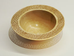 Turned wooden bowl with pierced rim